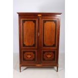 A 19TH CENTURY MAHOGANY AND SATINWOOD INLAID CUPBOARD the moulded cornice above an inlaid panelled