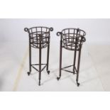 A PAIR OF WROUGHT IRON JARDINIERE STANDS each of circular form with open work frieze raised on