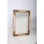 A CONTINENTAL POLYCHROME AND GILT MIRROR the rectangular bevelled glass plate within a moulded