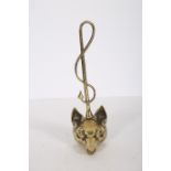 A BRASS DOOR STOP in the form of a fox's head with whip 40cm (h)