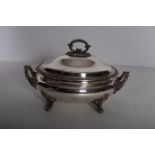 A 19TH CENTURY SILVER PLATED TWO HANDLED LIDDED TUREEN of oval outline with gadrooned decoration on