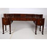 A GOOD GEORGIAN MAHOGANY SIDEBOARD of rectangular bowed outline the superstructure with shaped top