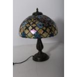 AN ART DECO DESIGN BRONZED TABLE LAMP with multicoloured mushroom shaped lead glass shade above a