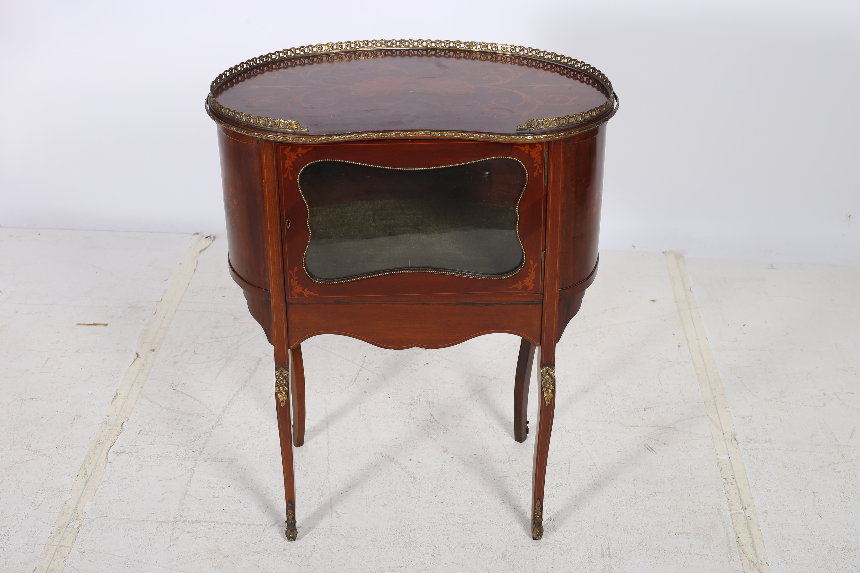 A CONTINENTAL MAHOGANY AND MARQUETRY SIDE CABINET of kidney shaped outline with pierced brass