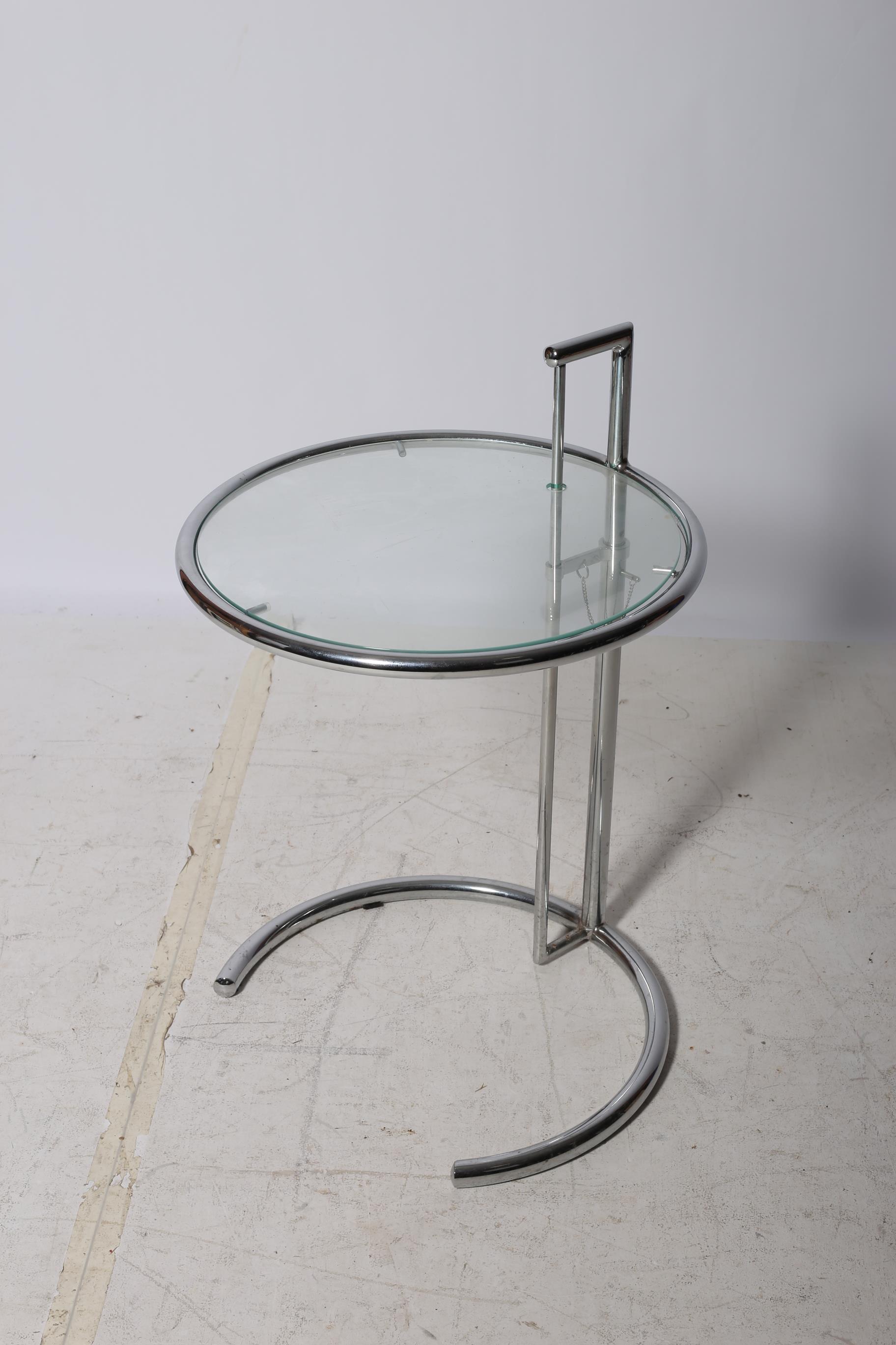 A RETRO CHROME AND GLAZED ADJUSTABLE COFFEE TABLE the circular top above a cylindrical column on