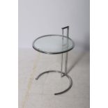 A RETRO CHROME AND GLAZED ADJUSTABLE COFFEE TABLE the circular top above a cylindrical column on