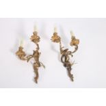 A PAIR OF 19TH CENTURY GILT BRASS TWO BRANCH WALL LIGHTS each with an intertwined foliate back