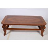 A CONTINENTAL WALNUT AND MARQUETRY COFFEE TABLE of rectangular outline with canted angles on carved