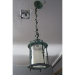 A BRONZE SINGLE LIGHT HALL LANTERN of cylindrical form with knopped columns suspended on a linked