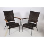 A PAIR OF RETRO HARDWOOD METAL AND HIDE UPHOLSTERED ELBOW CHAIRS each with a shaped back and seat