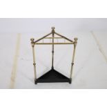 A 19TH CENTURY BRASS AND CAST IRON CORNER STICK STAND the triangular top with stick compartments