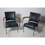 A PAIR OF RETRO HARDWOOD METAL AND HIDE UPHOLSTERED ELBOW CHAIRS each with a curved back and shaped