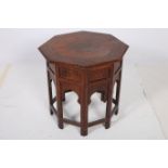AN ORIENTAL HARDWOOD AND BRASS INLAID TABLE of octagonal form on folding stand 51cm (h) x 51cm (w)