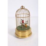 AN AUTOMATON SINGING BIRD IN GILT BRASS CAGE of circular dome form 28cm (h)
