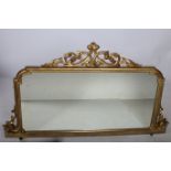 A 19TH CENTURY CARVED GILTWOOD OVER MANTLE MIRROR the rectangular plate within a shaped moulded and