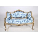 A CONTINENTAL HARDWOOD AND UPHOLSTERED SETTEE the serpentine top rail with shell and scroll carving