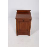 AN EDWARDIAN MAHOGANY INLAID FUEL BIN of rectangular form the shaped top with moulded back and
