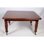 A WILLIAM IV TELESCOPIC DINING TABLE the rectangular top with rounded corners and two loose leaves