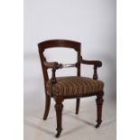 A 19TH CENTURY MAHOGANY LIBRARY ELBOW CHAIR stamped Strahan & Company Seriel number 0741 retailed