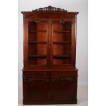 A 19TH CENTURY MAHOGANY LIBRARY BOOKCASE the moulded cornice with pierced carved cresting above a