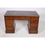 A 19TH CENTURY MAHOGANY PEDESTAL DESK of rectangular outline the shaped top with tooled leather