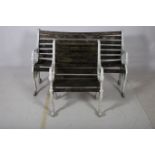 A CAST METAL GARDEN SEAT together with a chair and suite each with a slatted back and seat with
