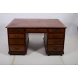 A GEORGIAN DESIGN MAHOGANY PARTNERS DESK of rectangular outline the shaped top with tooled leather