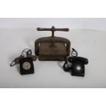 TWO BAKELITE TELEPHONES together with a 19th Century cast iron book press