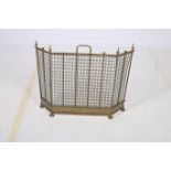 A 19TH CENTURY BRASS MESH SPARK GUARD of rectangular outline with canted angles on bun feet 55cm x