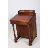 A VICTORIAN DESIGN MAHOGANY DAVENPORT the superstructure with hinged compartment above a tooled