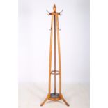 AN OAK HAT COAT AND STICK STAND the circular top with urn finials raised on rectangular supports