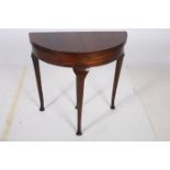 A QUEEN ANNE DESIGN MAHOGANY FOLD OVER CARD TABLE of demilune outline the shaped hinged top