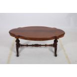 A 19TH CENTURY MAHOGANY COFFEE TABLE of serpentine outline the shaped top above dual baluster