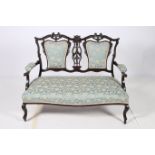 A 19TH CENTURY CARVED MAHOGANY AND UPHOLSTERED DOUBLE CHAIR BACK SETTEE the shaped top rail with