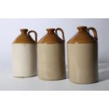 THREE GLAZED POTTERY WHISKY JARS of typical form each 32cm (h)