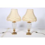 A PAIR OF CONTINENTAL CUT GLASS AND BRASS TABLE LAMPS each with an ovoid cut glass bowl above a