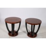 A PAIR OF CONTINENTAL KINGWOOD LAMP TABLES each with circular outline raised on shaped supports and