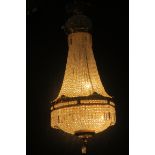 A FINE CONTINENTAL GILT BRASS AND CUT GLASS BASKET CHANDELIER hung with cascading pendent drops