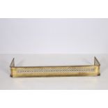 A 19TH CENTURY BRASS FENDER with pierced frieze on stepped base 16cm (h) x 125cm (w) x 32cm (d)