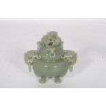 A JADE LIDDED JAR carved in relief with dragons elephant masks on claw feet 13cm x 14cm