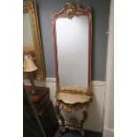 A CONTINENTAL GILTWOOD AND POLYCHROME CONSOLE TABLE AND MIRROR the rectangular plate within a