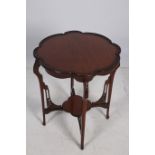 A 19TH CENTURY CARVED MAHOGANY INLAID OCCASIONAL TABLE the shaped top with carved rim on carved and