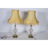 A PAIR OF CONTINENTAL GILT BRASS AND CUT GLASS TABLE LAMPS each of baluster form raised on a