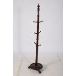 A 19TH CENTURY MAHOGANY COAT TREE the turned column issuing eight baluster shaped hooks above a