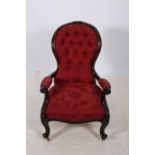 A 19TH CENTURY CARVED MAHOGANY AND UPHOLSTERED ARMCHAIR the shaped top rail with flower head