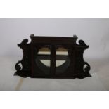 A 19TH CENTURY CARVED MAHOGANY AND GLAZED WALL MOUNTED CABINET the moulded cornice above a pair of