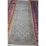 A BIDJAR WOOL RUNNER the light blue and beige ground with central panel filled with stylized flower