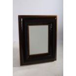 A GILT FRAME AND SIMULATED HIDE UPHOLSTERED MIRROR the rectangular bevelled glass plate within a