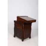 A GOOD REGENCY ROSEWOOD DAVENPORT of rectangular outline the sliding top with pierced brass gallery