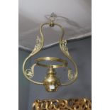 A 19TH CENTURY BRASS HANGING OIL LAMP the shaped frame with pierced foliate decoration and lobed